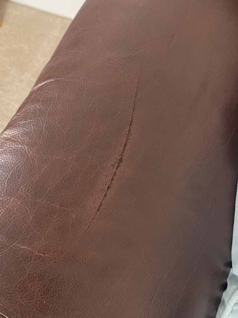 deep scratch on sofa arm before leather repair restoration