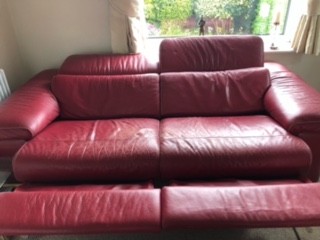 before image of a worn white leather sofa in need of repair